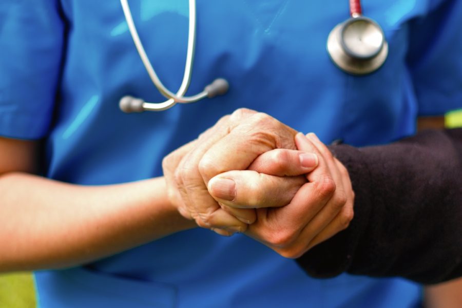 Doctor helping old patient with Alzheimer's disease.